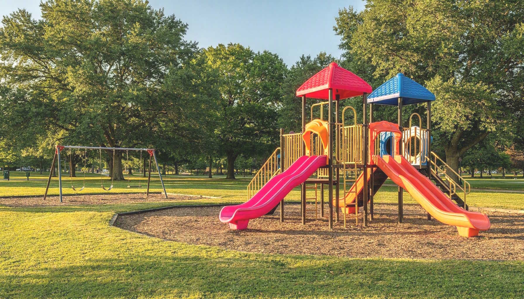 Children playing in a colorful playground on a sunny day